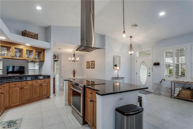 kitchen featuring brown cabinets, stainless steel electric range oven, visible vents, dark stone countertops, and island range hood