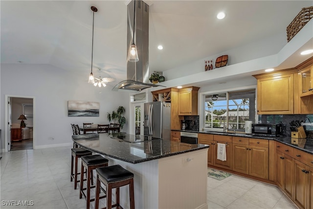 kitchen with black electric stovetop, island exhaust hood, stainless steel fridge with ice dispenser, decorative light fixtures, and vaulted ceiling