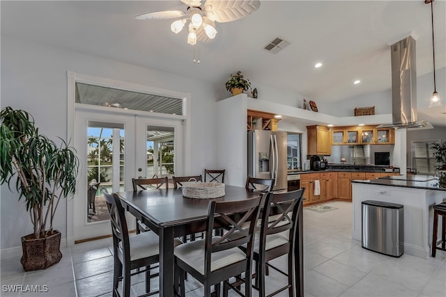 dining space with light tile patterned floors, visible vents, vaulted ceiling, french doors, and recessed lighting