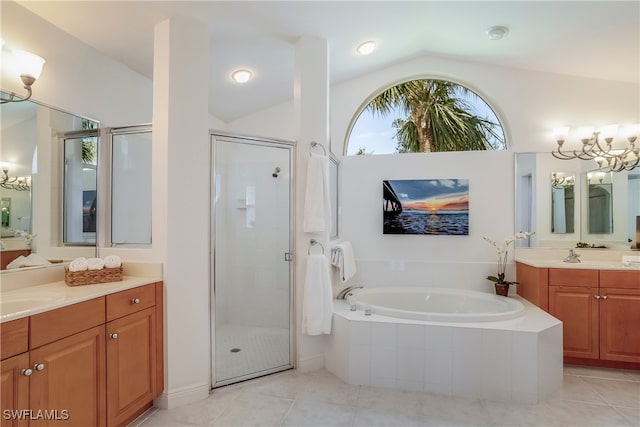 full bathroom with a garden tub, two vanities, vaulted ceiling, a shower stall, and tile patterned floors