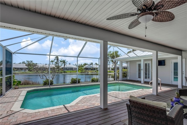 pool featuring a ceiling fan, a patio area, a lanai, and a water view