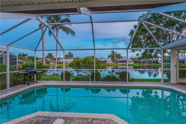 view of swimming pool with a water view, a grill, a patio, and glass enclosure