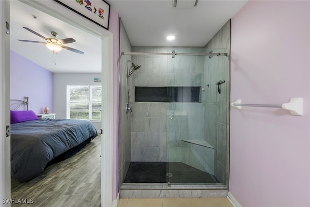 bathroom featuring walk in shower, ceiling fan, and hardwood / wood-style floors