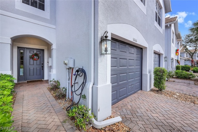 doorway to property with a garage