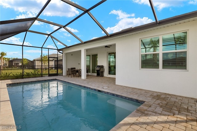 view of pool featuring a patio, ceiling fan, a lanai, and grilling area