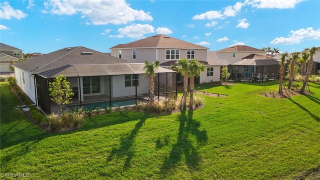 back of house featuring a pool, a lanai, and a lawn