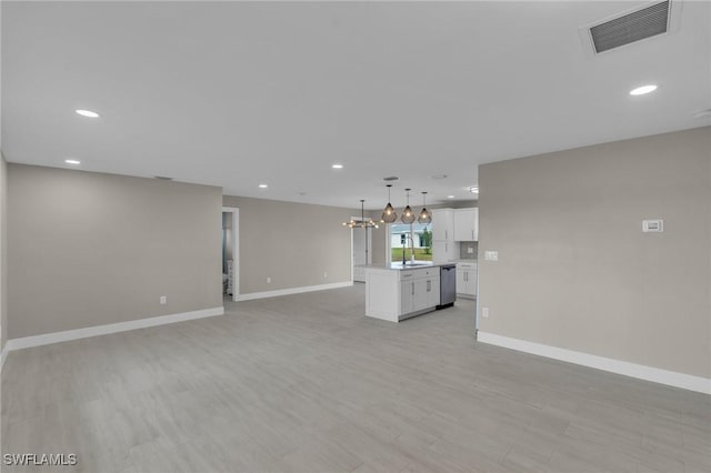 unfurnished living room with sink and light wood-type flooring