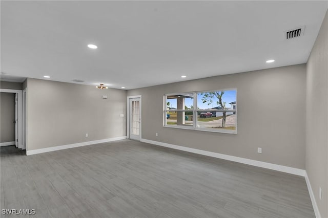 empty room with light hardwood / wood-style floors