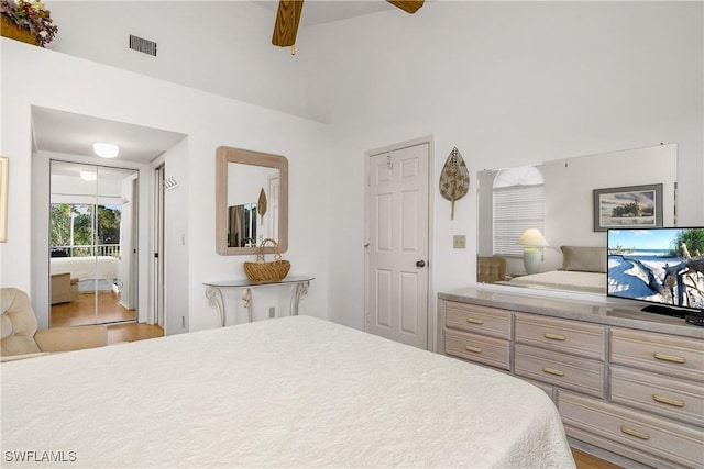 bedroom with ceiling fan, beamed ceiling, and hardwood / wood-style flooring