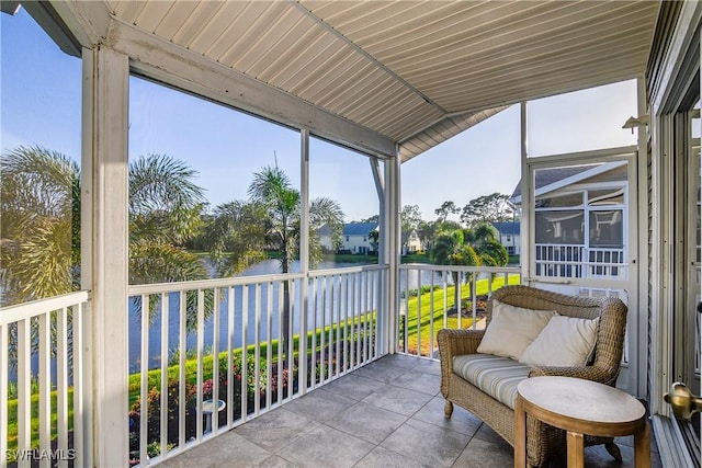 sunroom / solarium featuring a water view, wooden ceiling, and lofted ceiling