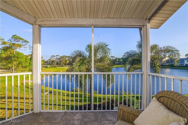 unfurnished sunroom with plenty of natural light, a water view, and wood ceiling