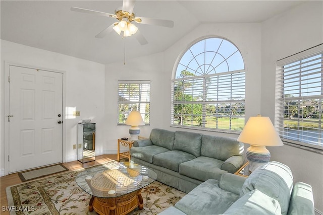 living room featuring ceiling fan, lofted ceiling, and light hardwood / wood-style flooring