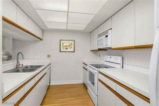 kitchen with white cabinetry, light wood-type flooring, white appliances, and sink