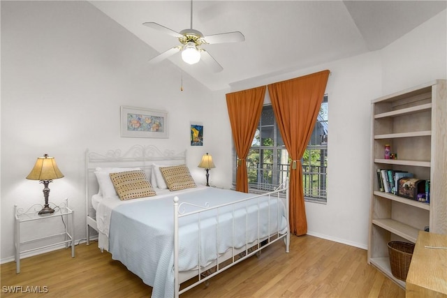 bedroom with ceiling fan, lofted ceiling, and light wood-type flooring