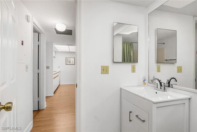 bathroom with vanity and wood-type flooring