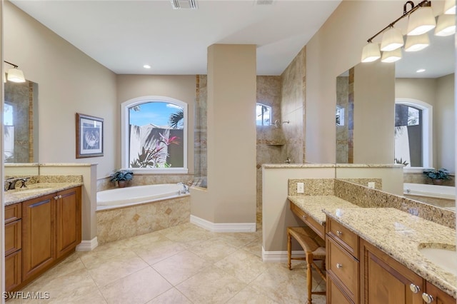 bathroom featuring vanity, independent shower and bath, and tile patterned floors