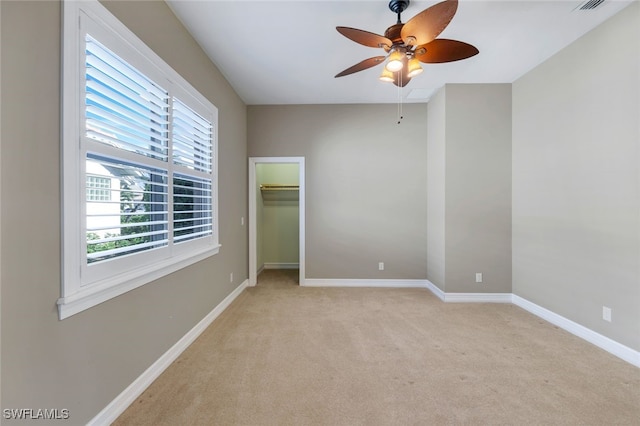 unfurnished bedroom with ceiling fan and light colored carpet