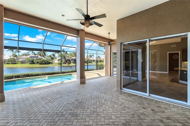 view of swimming pool featuring a patio area, a water view, ceiling fan, and a lanai