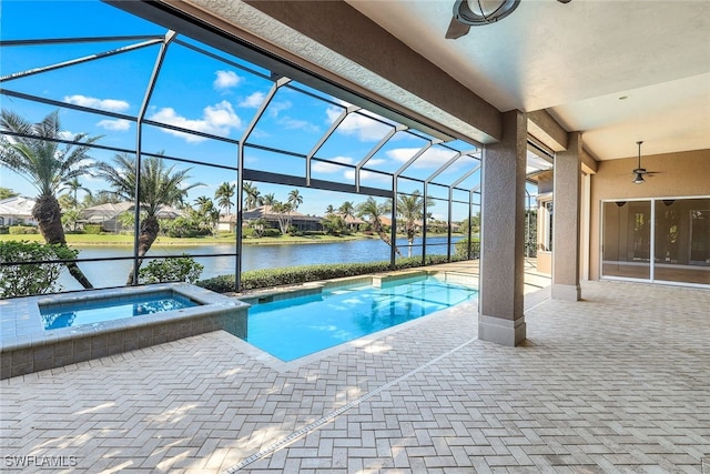 view of swimming pool featuring an in ground hot tub, a water view, a lanai, and a patio area