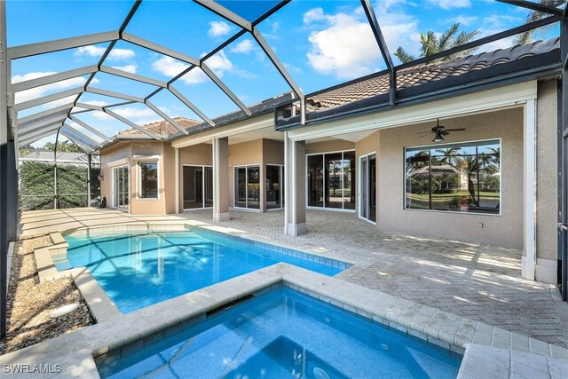 view of pool with ceiling fan, a patio area, a lanai, and an in ground hot tub