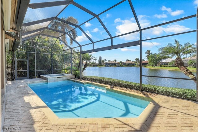 view of swimming pool with an in ground hot tub, a water view, a patio area, and a lanai