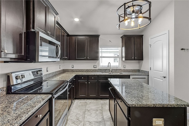 kitchen with a center island, stone counters, an inviting chandelier, sink, and stainless steel appliances