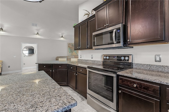 kitchen featuring light stone counters, dark brown cabinetry, stainless steel appliances, and light tile patterned floors