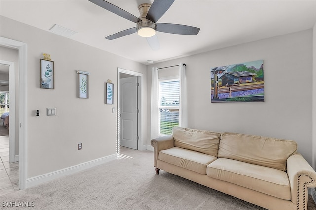 living room featuring ceiling fan and light colored carpet