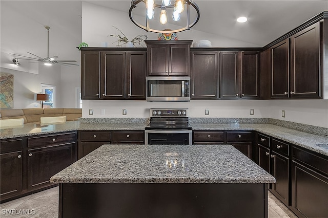 kitchen featuring dark brown cabinetry, light stone countertops, a center island, stainless steel appliances, and lofted ceiling