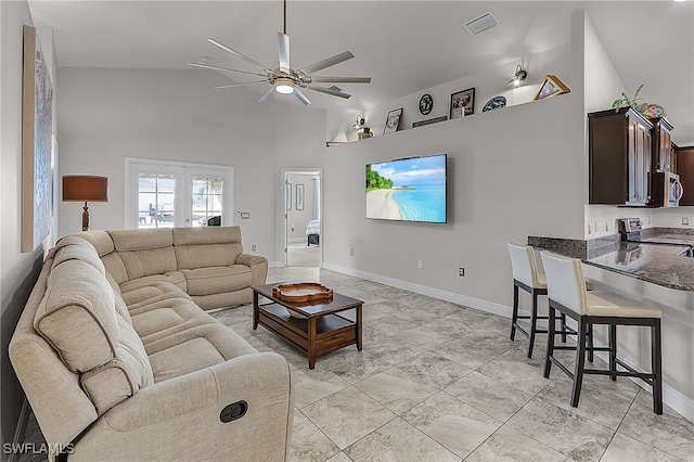 living room with ceiling fan and high vaulted ceiling