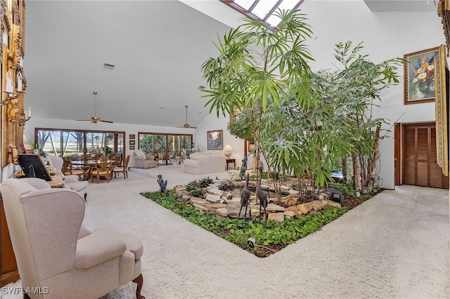 living room featuring carpet, ceiling fan, and high vaulted ceiling