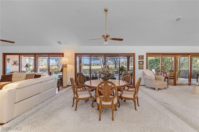 carpeted dining area featuring ceiling fan and a healthy amount of sunlight