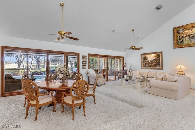 dining room with carpet floors, high vaulted ceiling, and ceiling fan