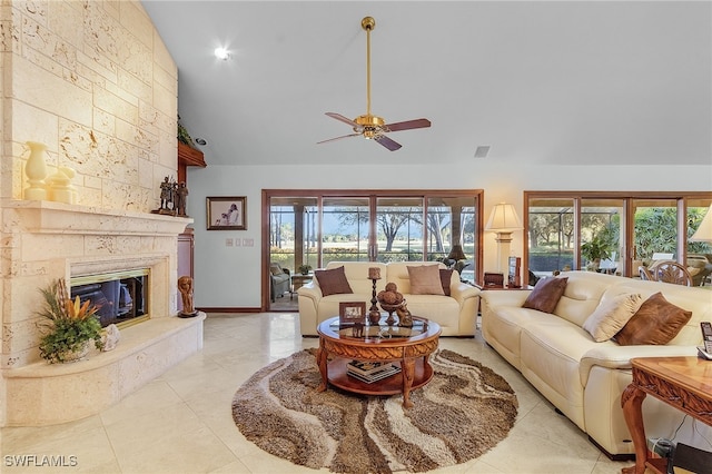 living room with a fireplace, high vaulted ceiling, plenty of natural light, and ceiling fan