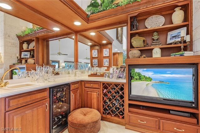 bar featuring ceiling fan, sink, beverage cooler, and tile walls