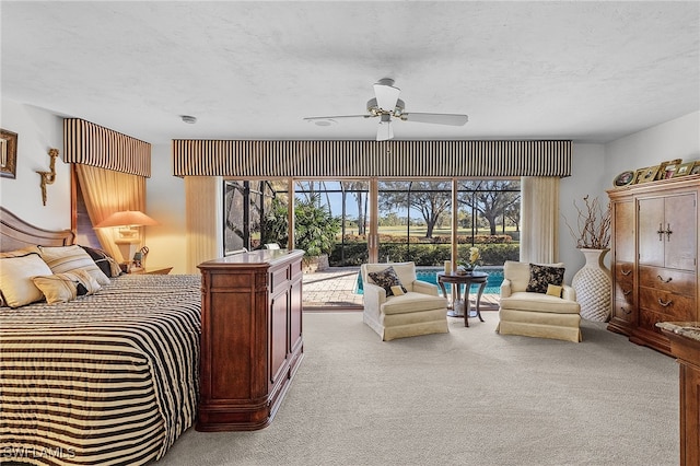 carpeted bedroom with ceiling fan and a textured ceiling