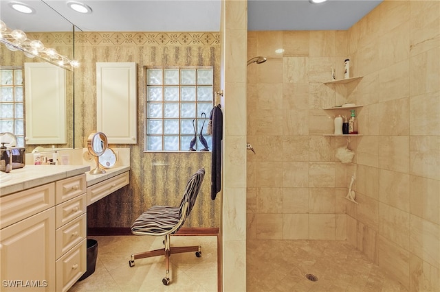 bathroom featuring tiled shower, vanity, and tile patterned floors