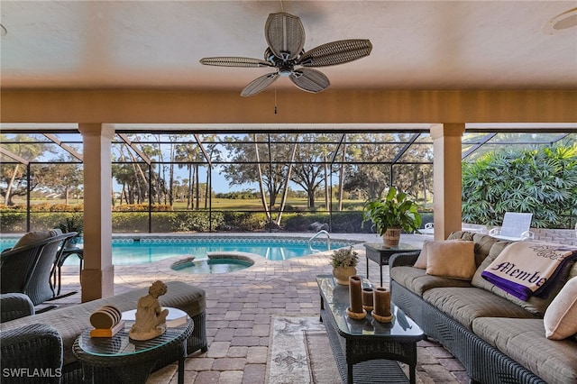 view of pool featuring a lanai, a patio area, an in ground hot tub, and an outdoor living space