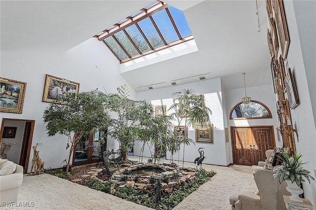 interior space featuring high vaulted ceiling, a healthy amount of sunlight, and track lighting