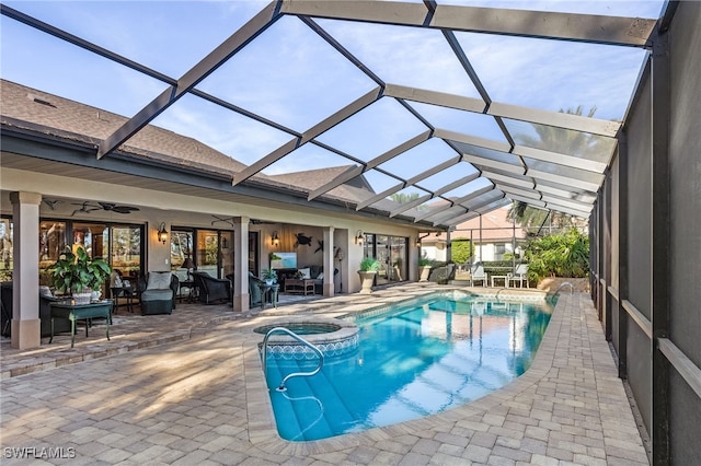 view of swimming pool with a lanai, ceiling fan, a patio, and an in ground hot tub