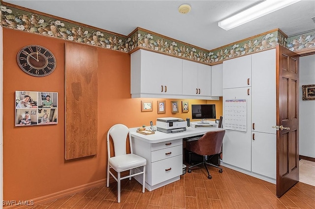 office area with light wood-type flooring and ornamental molding