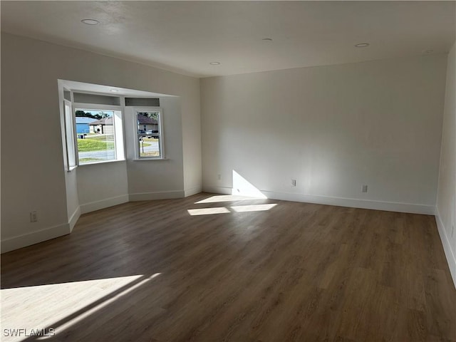 empty room with dark wood-type flooring