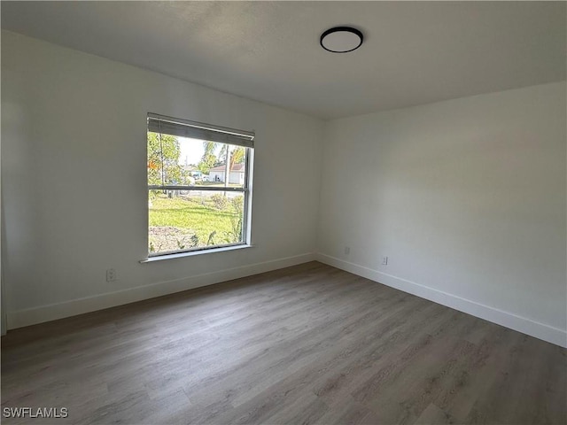 spare room with hardwood / wood-style flooring