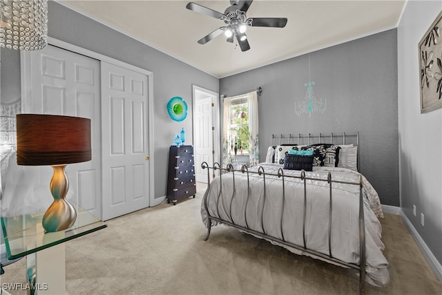 bedroom featuring ceiling fan, a closet, and light colored carpet