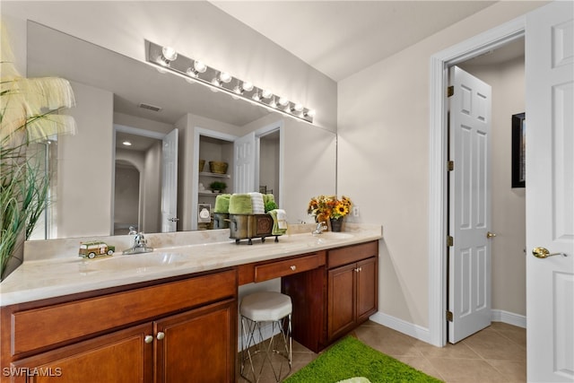 bathroom with tile patterned flooring and vanity