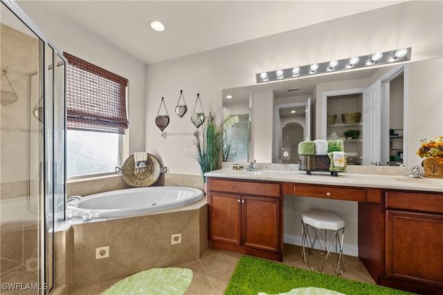 bathroom featuring tile patterned floors, vanity, and plus walk in shower