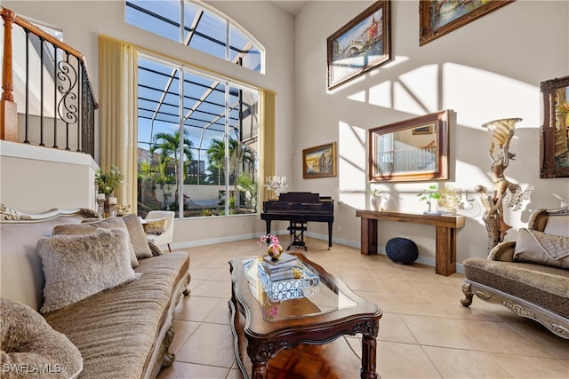 tiled living room featuring plenty of natural light and a high ceiling