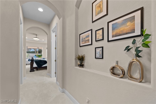 corridor featuring light colored carpet