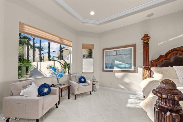 sitting room with a tray ceiling, light carpet, and crown molding