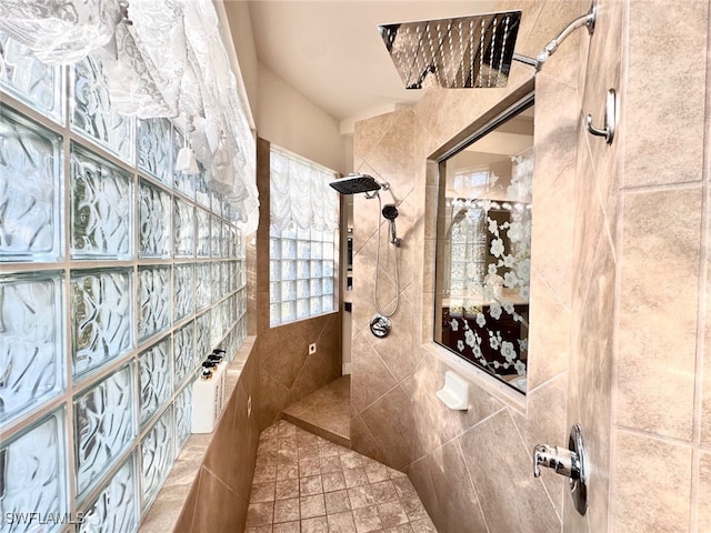 bathroom featuring a tile shower and tile walls